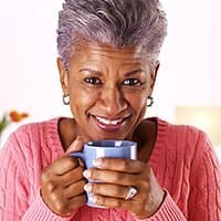 Middle Aged Woman holding cup of coffee