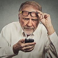 Older man struggling to see phone screen