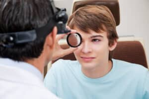 doctor examining dilated pupils of a patient